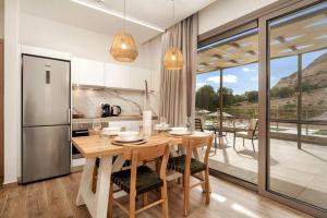a kitchen and dining room with a table and a refrigerator at Kayy Apartments 3 in Matala in Matala