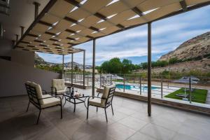 a living room with a view of a pool at Kayy Apartments 3 in Matala in Matala