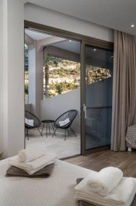 a bedroom with a bed and a patio with chairs at Kayy Apartments 3 in Matala in Matala