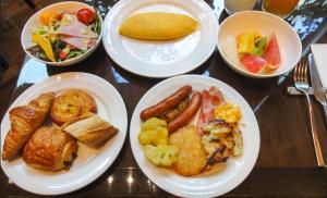 a table with plates of breakfast food on it at A's Place - Your Private Resort! in Valencia