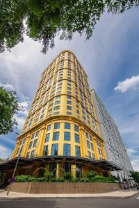 a tall yellow building with a sky at Dolce by Wyndham Hanoi Golden Lake in Hanoi