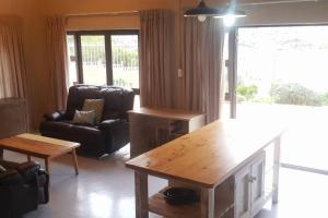 a living room with a couch and a table at Glencairn Haven in Cape Town