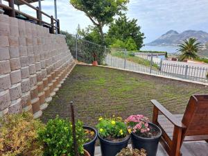 a garden with flowers in pots next to a wall at Glencairn Haven in Cape Town