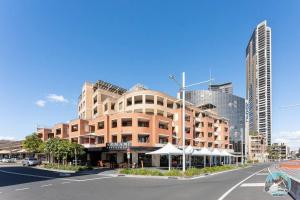 a large brick building on a city street at Aircabin - Parramatta - Free Parking - 1 Bed Apt in Sydney