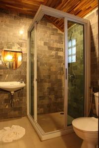 a bathroom with a shower and a toilet and a sink at Busai Country View in Wang Nam Khieo