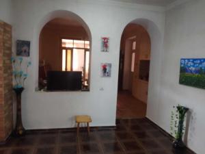 a room with two arches and a television on a wall at natia in Telavi