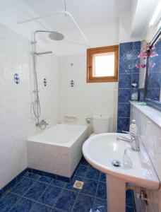 y baño con bañera, lavamanos y ducha. en Zefiros House, en Frangokastello
