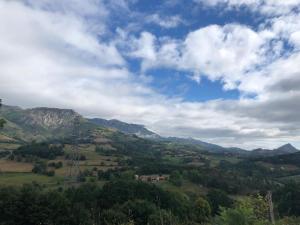 a view of a valley with mountains under a cloudy sky at Ca Bastiana in La Piñera