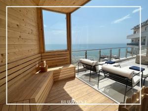 a balcony with chairs and a view of the ocean at Luxury Rooftop Suites by Blumont in Durrës