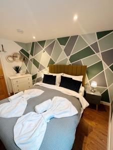 a bedroom with a bed with two towels on it at 2 Southwell Road - Luxurious City Centre Apartments in Norwich
