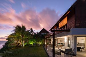 a house with a view of the ocean at sunset at Villa Saphir by muse villas in Bambous