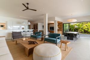 a living room and kitchen with a table and chairs at Villa Saphir by muse villas in Bambous