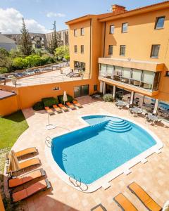 a large swimming pool in front of a building at Hotel D. Luis - Elvas in Elvas