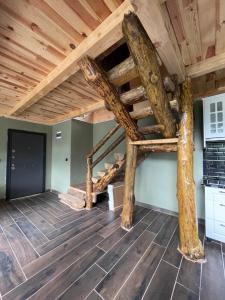 a loft conversion with wooden ceilings and wooden flooring at Riona dağ evleri in Çamlıhemşin