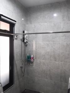 a bathroom with a shower with a glass door at ONE DD HOMES in Udon Thani