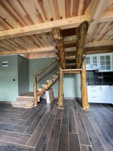 a loft bed in a room with a wooden ceiling at Riona dağ evleri in Çamlıhemşin