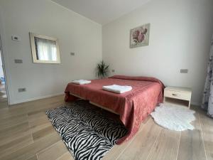 a room with a bed with a zebra blanket on the floor at Appartamento Miramare in Rimini