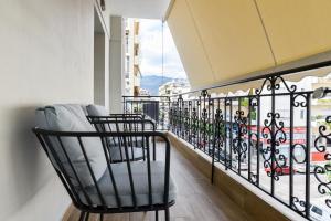 a balcony with two chairs and a view of a city at La Perla Apartments in Kalamata