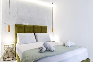Postel nebo postele na pokoji v ubytování La Perla Apartments