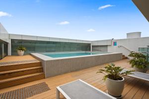a swimming pool on the deck of a building at Signature Residences in Wollongong