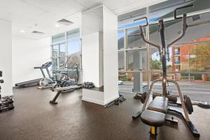 a gym with several treadmills and elliptical machines at Signature Residences in Wollongong