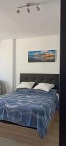 a bedroom with a bed with a blue comforter at Buenavista Estudio Torremolinos in Torremolinos