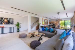 a living room with a couch and a table at Villa Nounja Golf Amelkis Marrakech in Marrakech