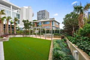 a lawn in front of a building at Signature Residences in Wollongong