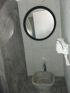 a small bathroom with a toilet and a mirror at Anatoli Studios in Schinoussa