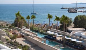 a view of a resort with a swimming pool and the ocean at Avant Mar Paros in Naousa
