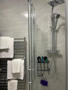a bathroom with a shower with a glass door at Kingdom apartments in Wolverhampton