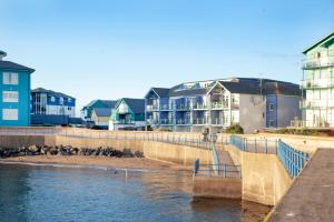 a group of houses next to a body of water at Beacon House in Exmouth