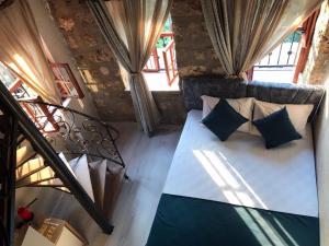 a room with a bed with pillows on it at grand friends in Antalya
