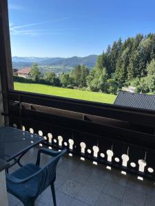 a balcony with a table and chairs and a view at Haus Gruber in Feldkirchen in Kärnten