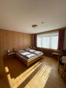 a bedroom with a large bed in a room at Haus Gruber in Feldkirchen in Kärnten