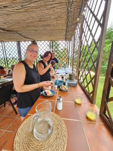 a group of people standing around a table with food at Finca la Yuca in Ontinyent