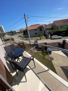 a chair and a table on the balcony of a house at Casa Marisa in Eforie Nord