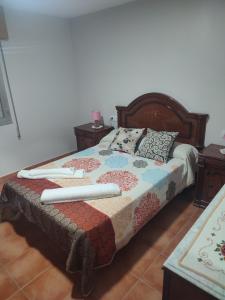 a bedroom with a bed with two pillows on it at Casa Tía María in Villanueva de Arosa
