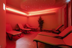 a waiting room with red chairs and a ceiling at Boutique Hotel Kaštel, Wellness & SPA, Pet Friendly in Motovun