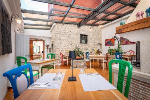 a dining room with tables and chairs and a brick wall at Boutique Hotel Kaštel in Motovun