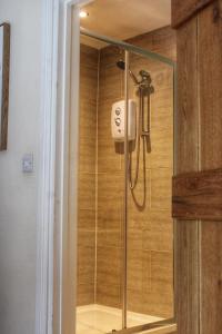 a shower in a bathroom with a glass door at Cosy One Bed Barn Conversion Donington Park East Midlands Airport in Derby +43 photos