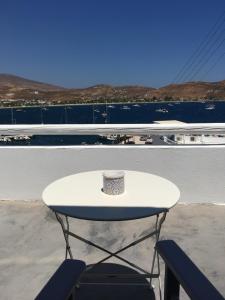 a coffee cup sitting on a table on a balcony at Cristi Rooms in Livadi +22 photos