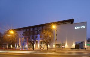 a building on a street at night with street lights at Dorint City-Hotel Salzburg in Salzburg