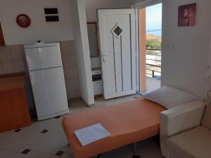 a living room with a couch and a refrigerator at Apartmani Drage in Drage