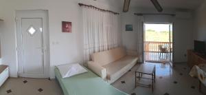 a living room with a couch and a window at Apartmani Drage in Drage