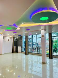 a large room with a ceiling with purple and green lights at Smart Stays - MMMUT College - GKP Airport in Gorakhpur