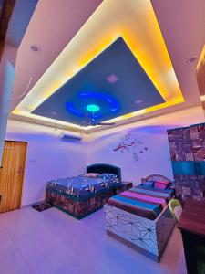 a room with two beds and a ceiling at Smart Stays - MMMUT College - GKP Airport in Gorakhpur