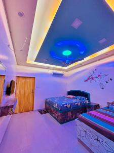 a room with two beds and a blue ceiling at Smart Stays - MMMUT College - GKP Airport in Gorakhpur