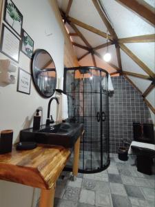 a bathroom with a black sink and a shower at Siya dome & glamping in Çamlıhemşin