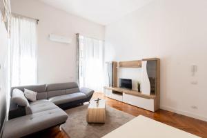 a living room with a couch and a tv at Loft2 via morosini centro Varese - Ixihome in Varese